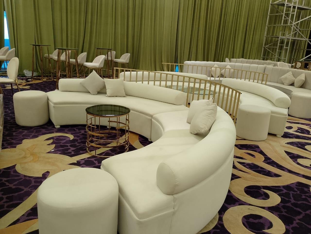 Curved lounge seating with gold accent tables