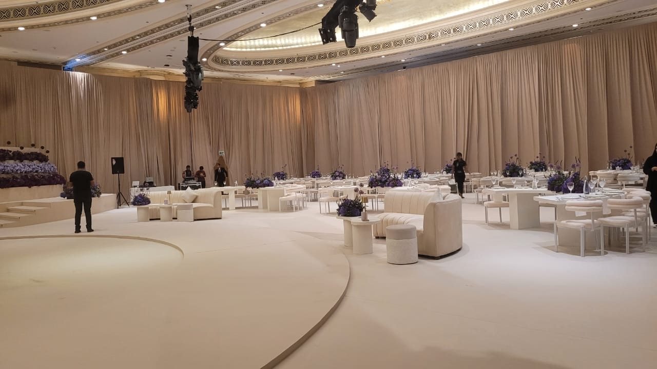 Cream ballroom setup with lounge seating and dining tables